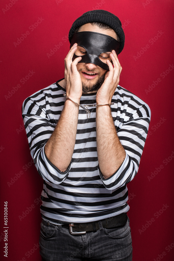 Sad thief with handcuffs Sad thief with handcuffs