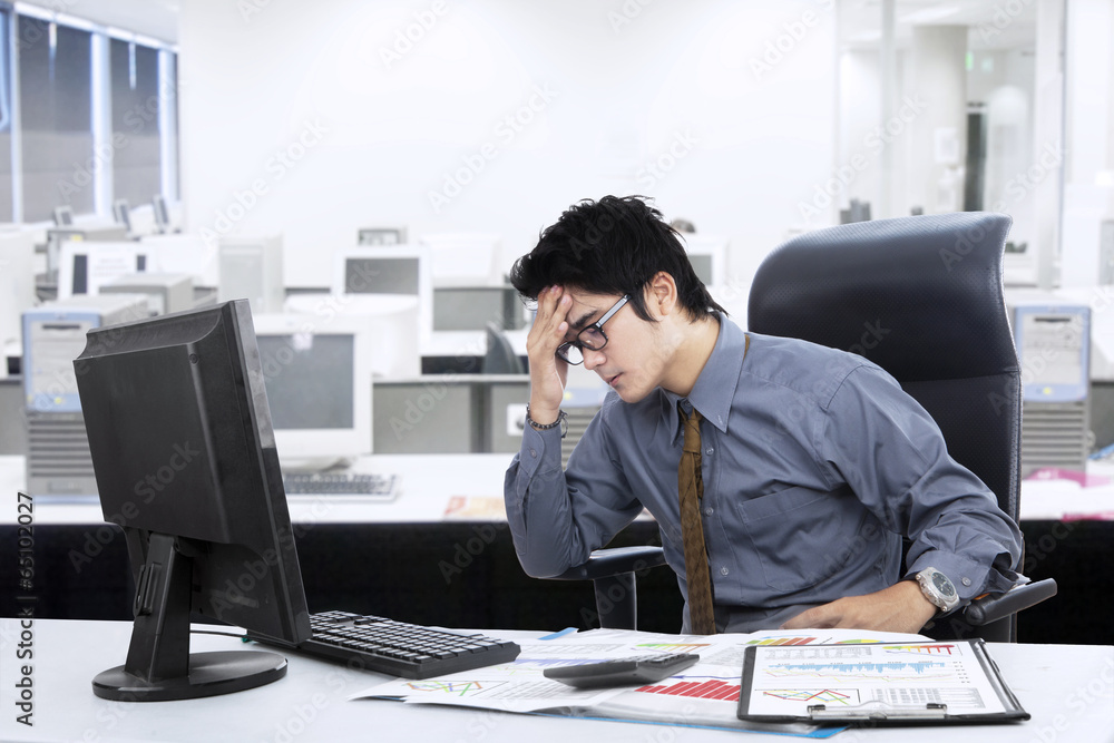 Confused asian businessman at office Confused asian businessman at office
