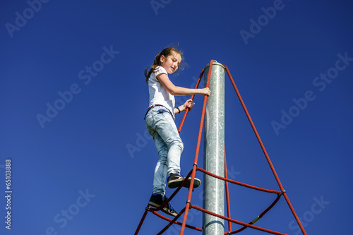 Teenage girl playing on child playground © 31etc