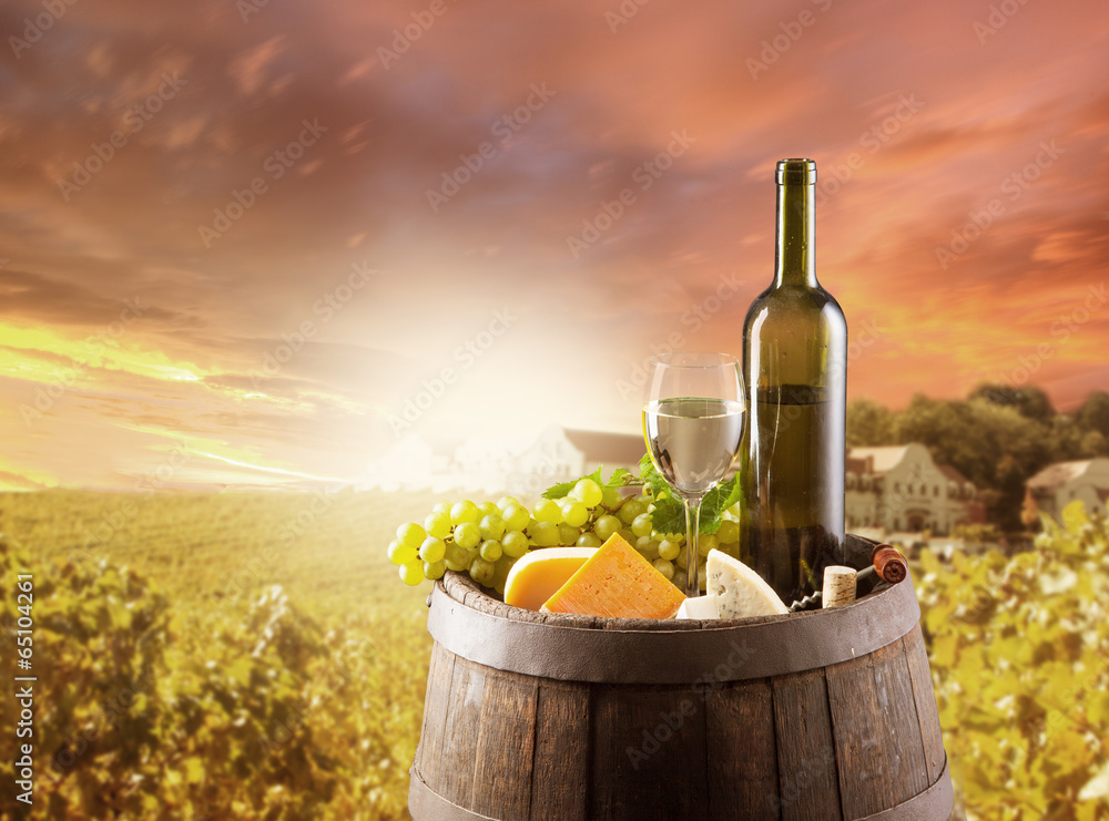 White wine still life with vineyard on backgorund