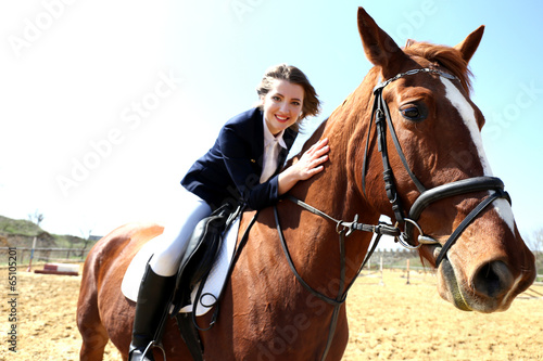 Beautiful girl riding a horse outdoors © Africa Studio