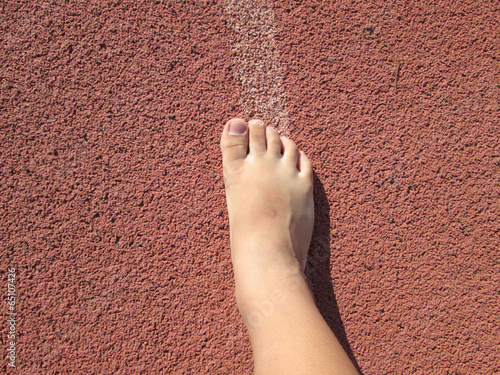 Boy foot on running track - for the athletes