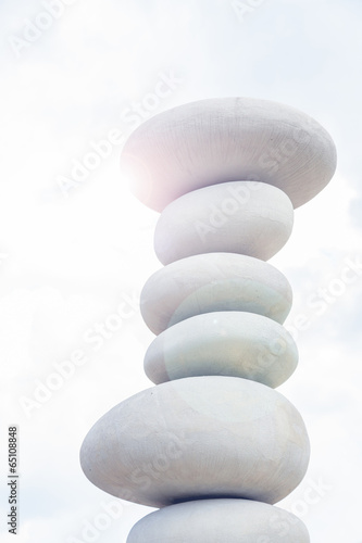 balancing stones against blue sky