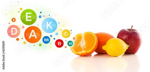 Healthy fruits with colorful vitamin symbols and icons photo