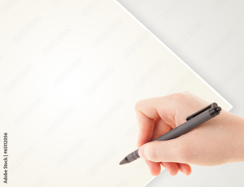 A person writing on a plain blank paper with a balpoint pen A person writing on a plain blank paper with a balpoint pen