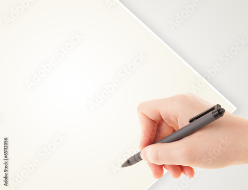 A person writing on a plain blank paper with a balpoint pen