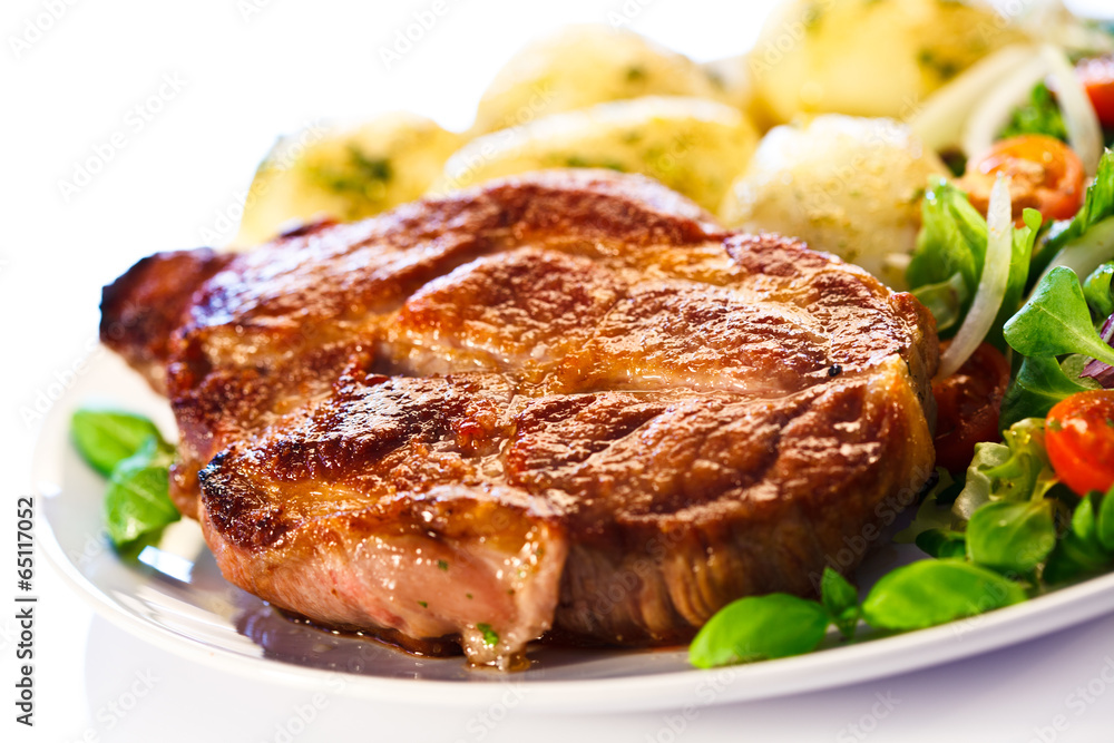 Grilled steak, boiled potatoes and vegetable salad Grilled steak, boiled potatoes and vegetable salad