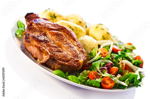 Grilled steak, boiled potatoes and vegetable salad