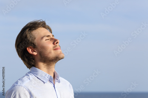 Fotografie Happy young man breathing deep