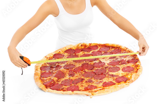 Fotografie Woman measuring huge pizza
