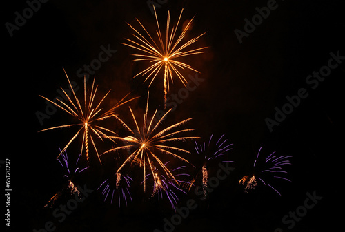 Violet and yellow fireworks at night