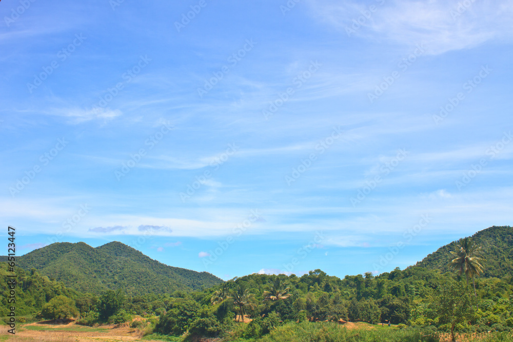 green mountains and blue sky on background
