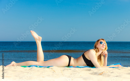 Summer vacation Girl in bikini sunbathing on beach