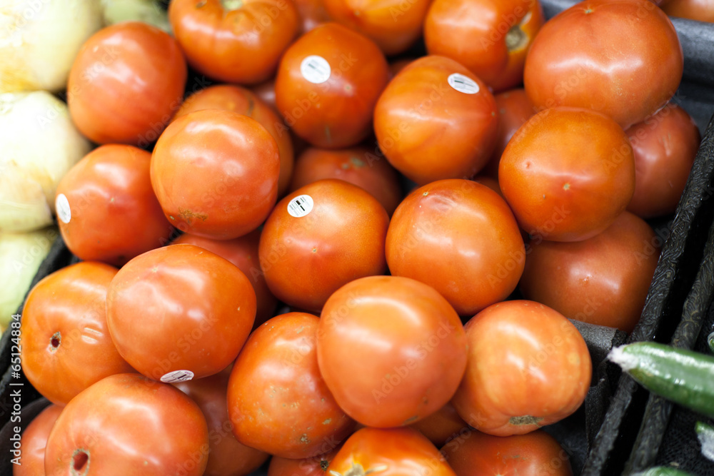 Tomatoes for sale at a market stall Tomatoes for sale at a market stall