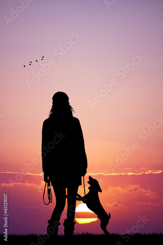 Girl with dog at sunset