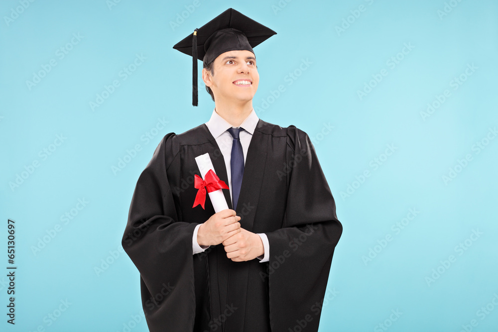 Proud male graduate student holding a diploma Proud male graduate student holding a diploma