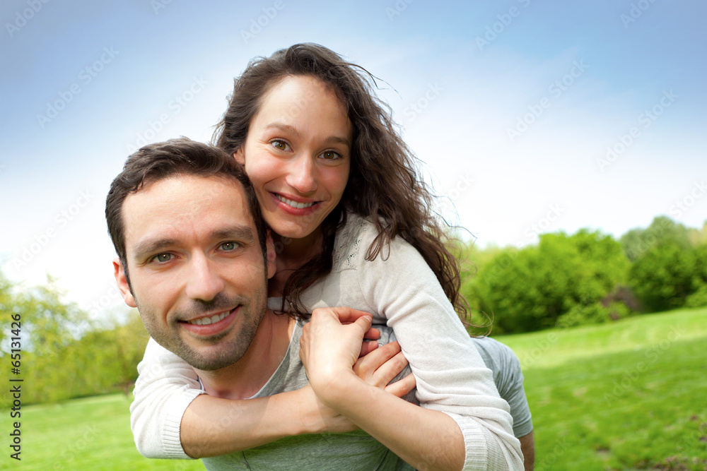 Young happy couple having fun at the park Young happy couple having fun at the park