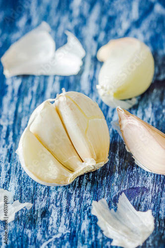 Organic garlic cloves on the wooden background