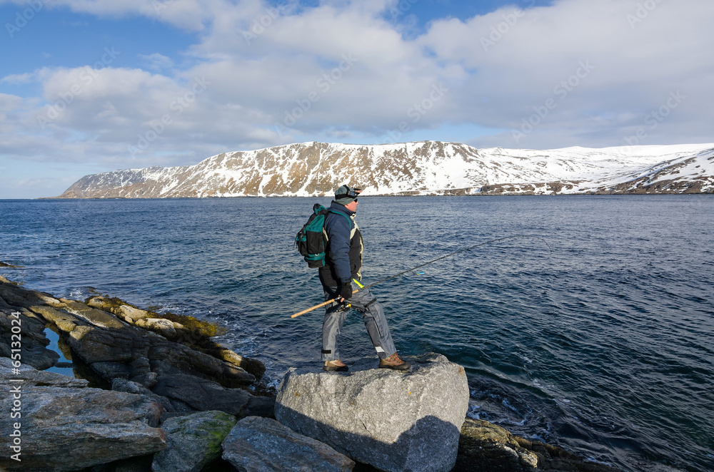Lonely angler on Norwegian sea coast