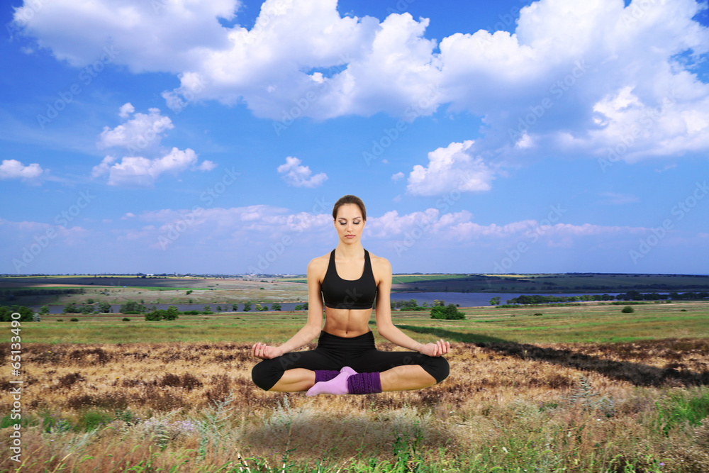 Beautiful girl fly and meditating in yoga pose