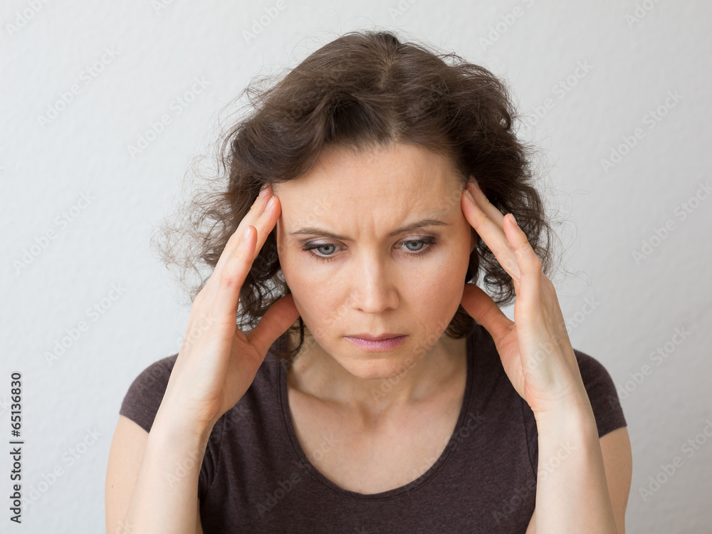 Woman thinking about seriously or with headache Woman thinking about seriously or with headache