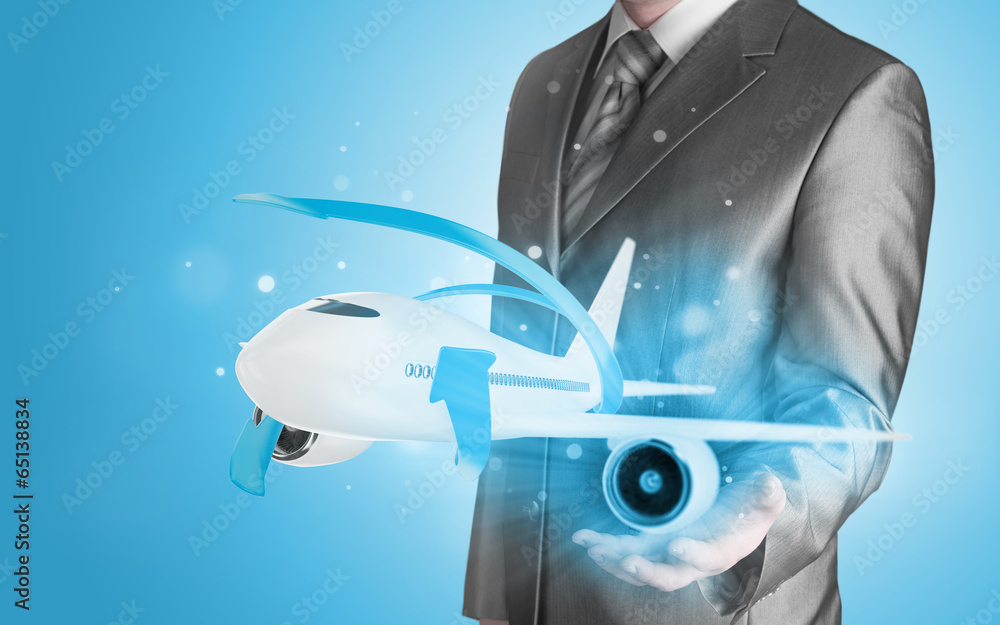 Businessman with airplane over his hand Businessman with airplane over his hand