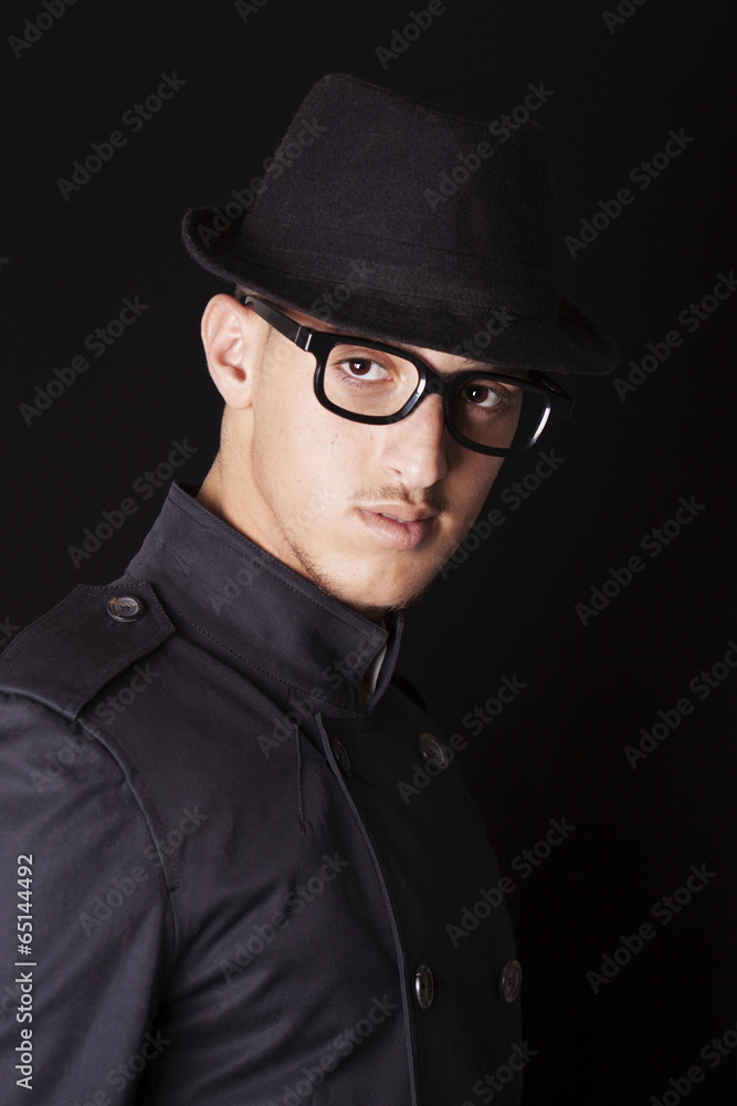 Man wearing hat, glasses and black coat Man wearing hat, glasses and black coat