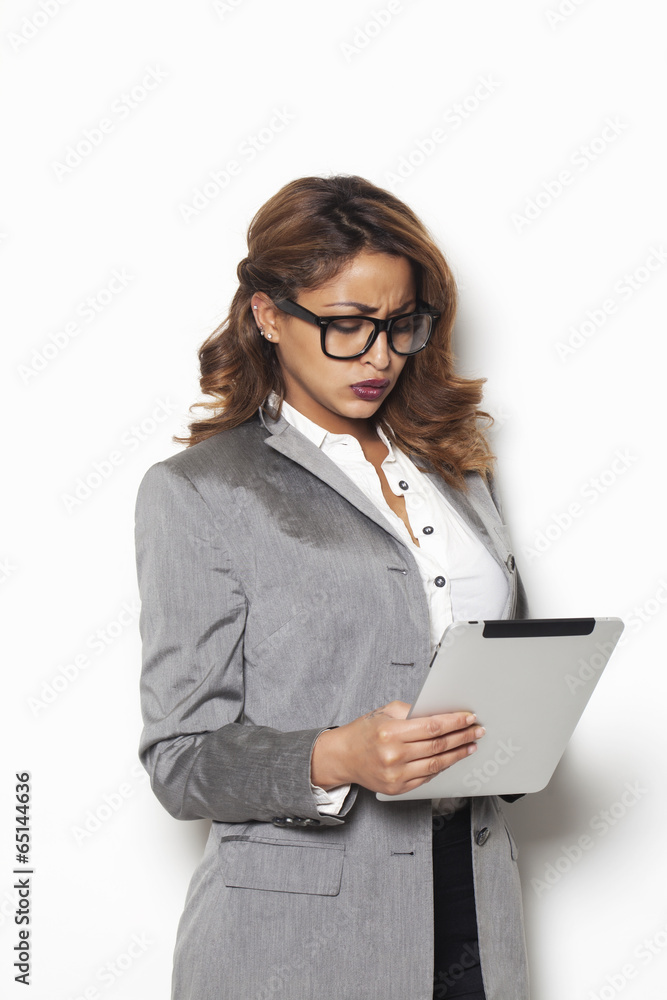 Disappointed businesswoman looking at the tablet Disappointed businesswoman looking at the tablet