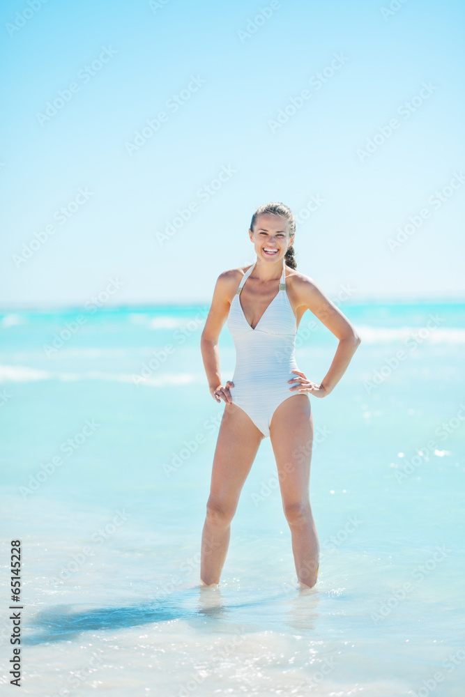 Full length portrait of young woman at seaside Full length portrait of young woman at seaside