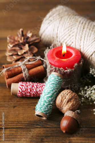 Composition with natural bump, candle, thread, cinnamon sticks
