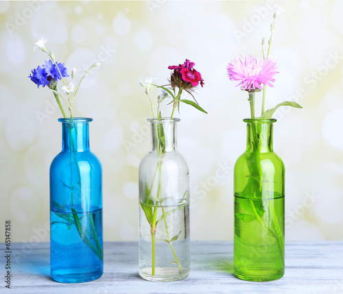 Fototapeta Naklejka Na Ścianę i Meble -  Bright wildflowers in bottles