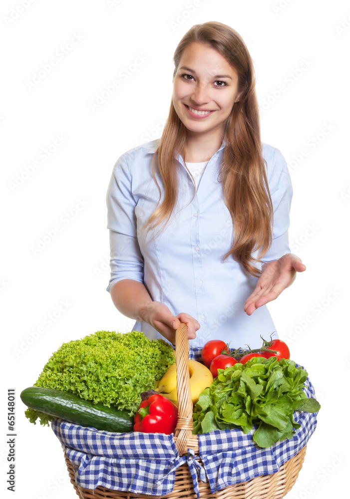 Attractive woman presenting a basket with fruits and vegetables Attractive woman presenting a basket with fruits and vegetables