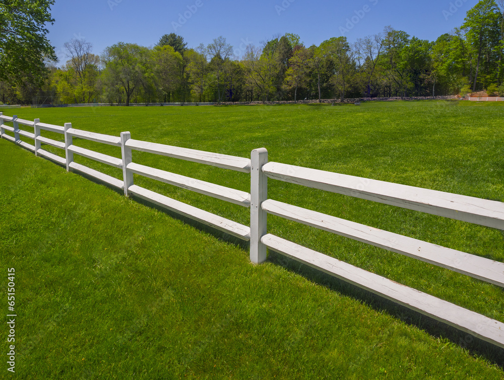 White fence on farm in Spring