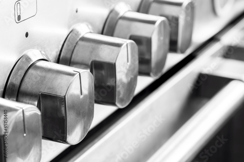 Tableau sur toile Close up image of stainless steel cooker knobs