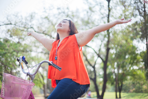 Happy woman posing with bicycle
