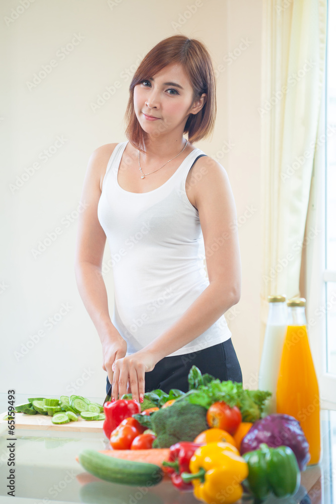 Happy woman cooking vegetables green salad Happy woman cooking vegetables green salad