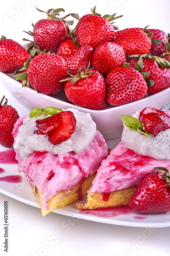 Delicious strawberry cake with ripe fruit in the background
