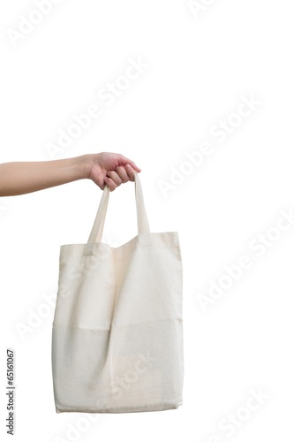 Hand of woman holding Fabric bag isolated on white background