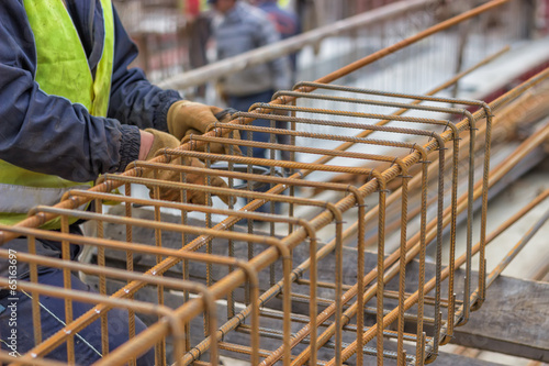 worker hands fixing steel reinforcement bars photo