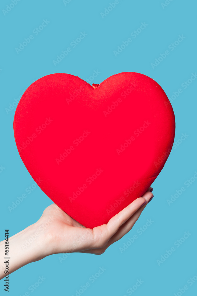 Hand holding shape heart on blue background. Hand holding shape heart on blue background.
