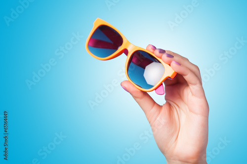 Hand holding sunglasses