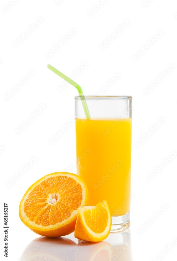 glass of orange juice with straw near half orange and slice