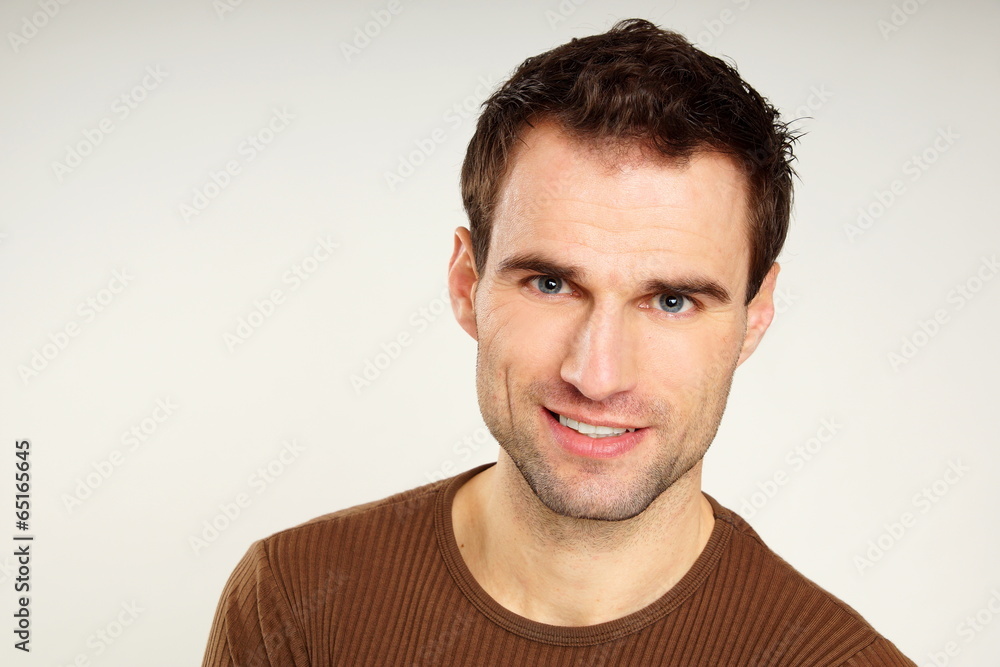 Fototapeta premium Portrait of handsome smiling man in brown shirt