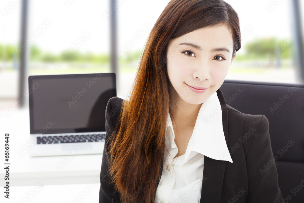 Fototapeta premium young confident businesswoman sitting in her office