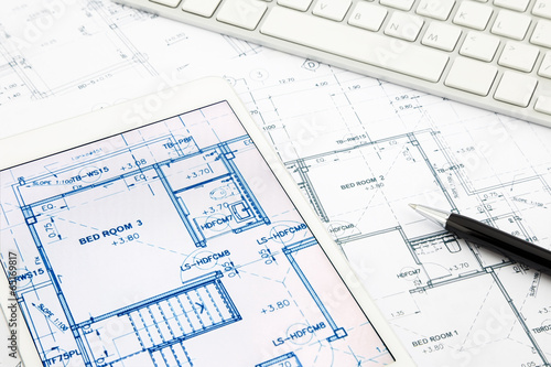 house blueprints and floor plan with tablet