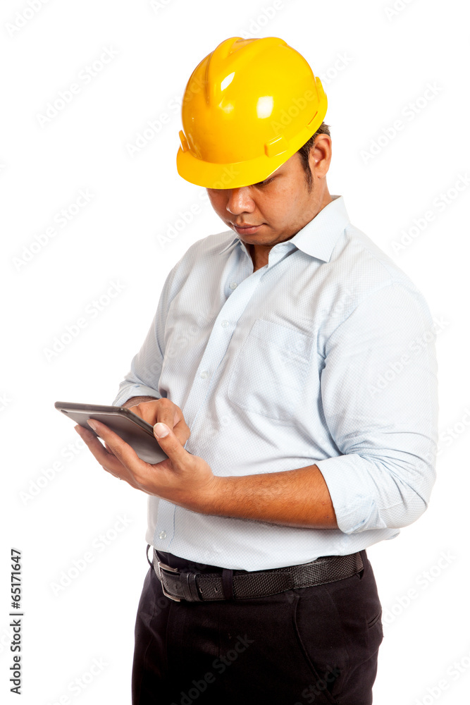 Asian engineer man with yellow hardhat look at his tablet Asian engineer man with yellow hardhat look at his tablet