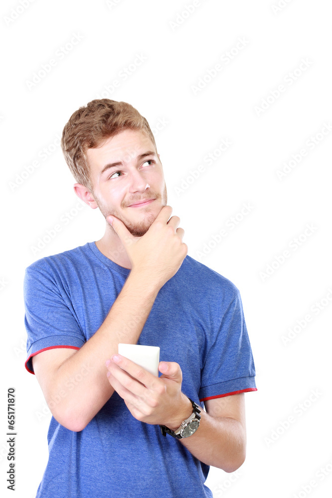 young male smiling using mobile phone and looking up young male smiling using mobile phone and looking up