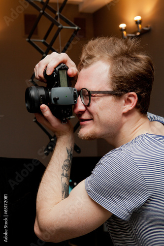 Photographer at work in photographic studio