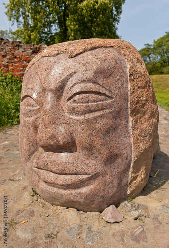 Stone face at Schwetz castle, Poland photo