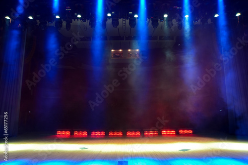 Illuminated empty concert stage with smoke